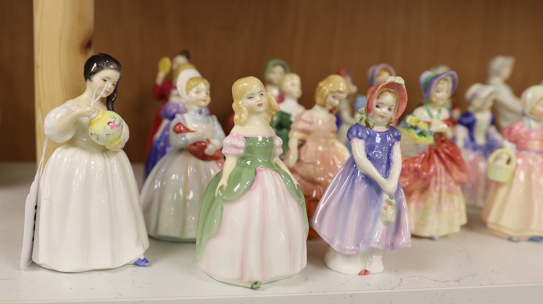 A collection of twenty five Royal Doulton figurines; Mandy, Penny, Ivy, the Rag Doll, Rose, Cissie, Tinkle Bell, Georgina, Julie, Andrea, Francine, Goody Two Shoes, Catherine, Helen, Anna, Dinky Do, Wendy, Belle, Marie,